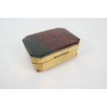 Red agate and brass snuff box, probably French, circa 1900, canted rectangular form on ball feet,