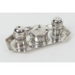 George V silver three piece condiment on stand, Birmingham 1927, comprising pepper pot, salt pot and