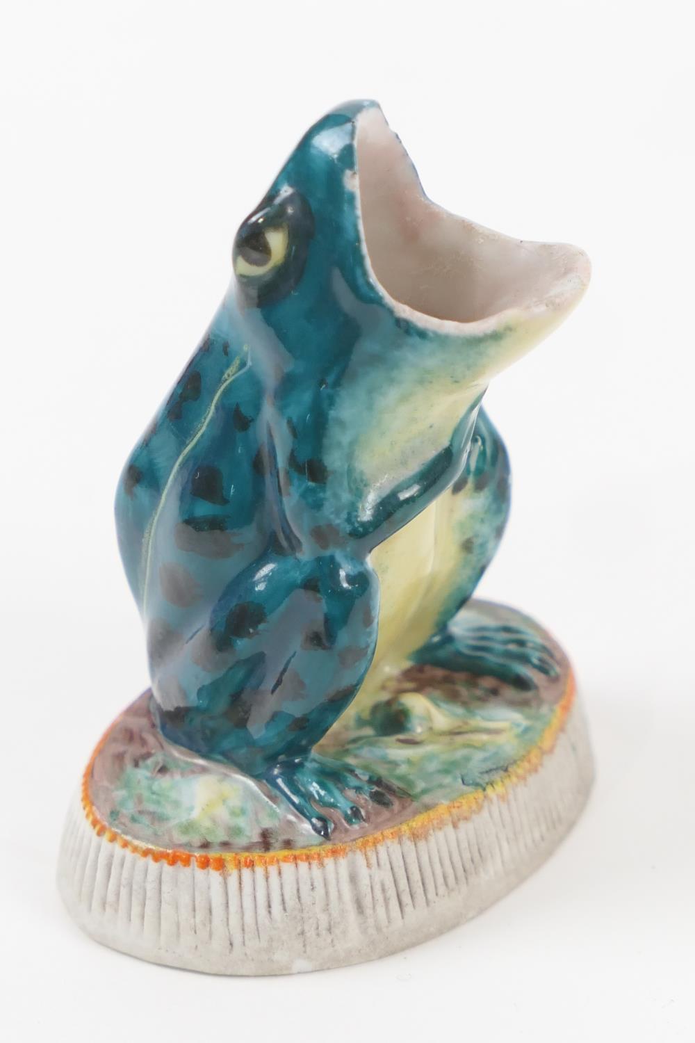 Unusual frog form match holder and striker, glazed colours on a bisque base, height 8cm