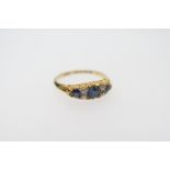 Sapphire and diamond cluster ring, set with three round cut sapphires of good colour, dispersed with