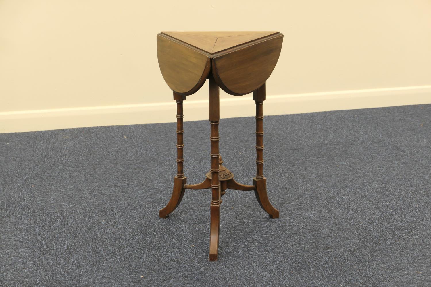 Late Victorian walnut swivel top occasional table, triangular form with demi-lune drop leaves,