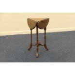 Late Victorian walnut swivel top occasional table, triangular form with demi-lune drop leaves,