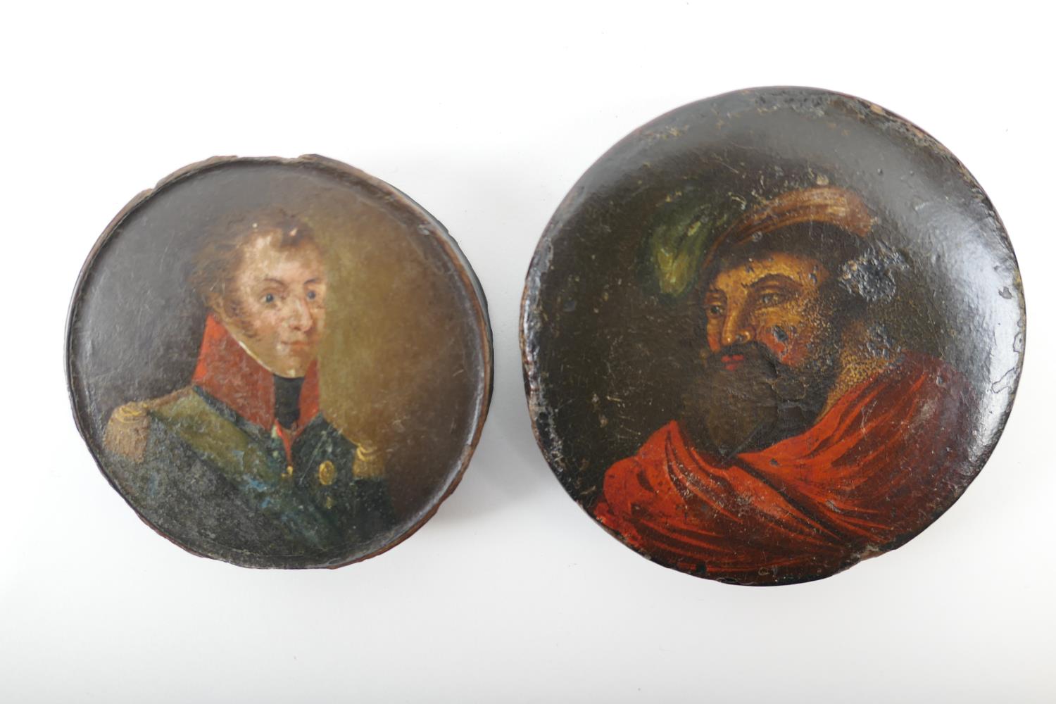 Two papier mache portrait snuff boxes, early 19th Century, one decorated with the bust of a young