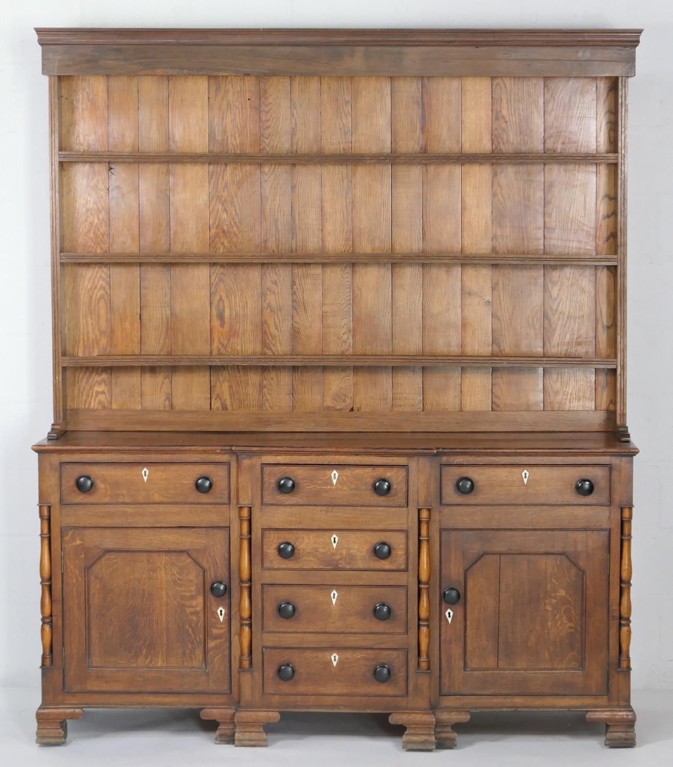 Montgomery oak enclosed dresser, circa 1820-40, with later plate rack, having three shelves over a