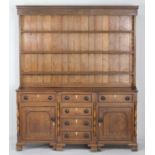 Montgomery oak enclosed dresser, circa 1820-40, with later plate rack, having three shelves over a