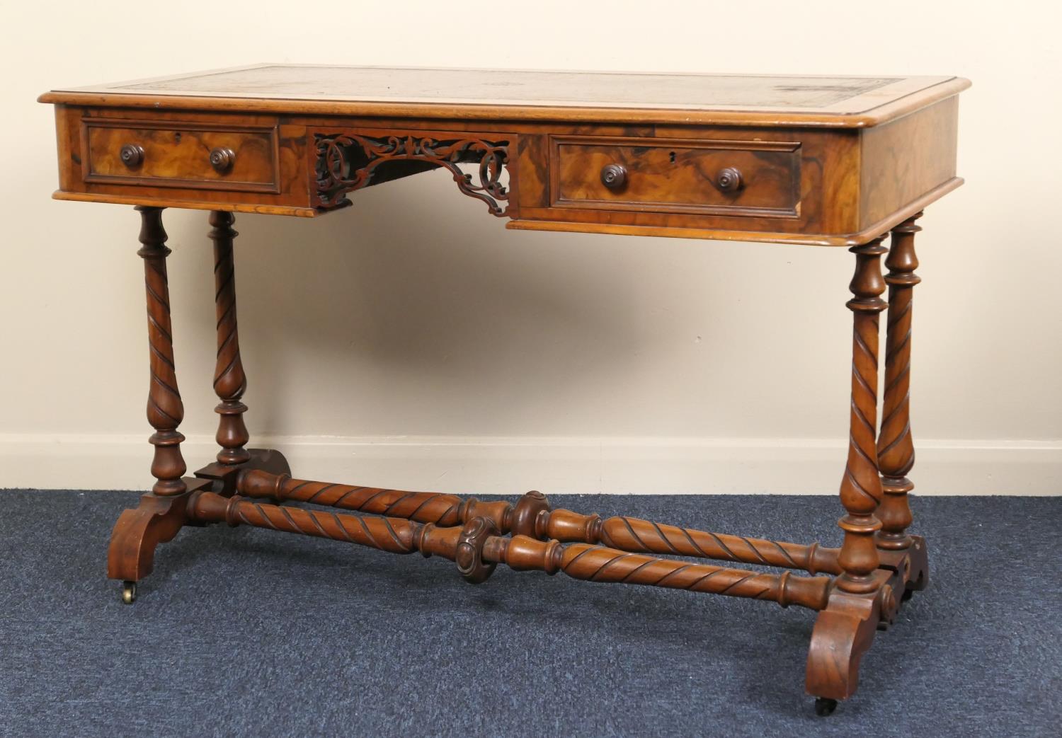 Victorian burr walnut kneehole writing table, with tooled leather inset top, over a fretwork