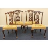 Four Edwardian mahogany dining chairs, in Chippendale style, each with pierced splat backs,