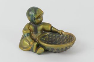 Zsolnay iridescent green glazed figural table salt, modelled as a child with a basket, gilt