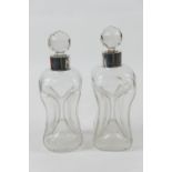 Pair of silver mounted clear glass kluk-kluk decanters, the collars hallmarked Birmingham 1912, with