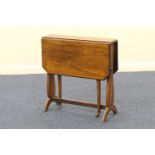 Late Victorian rosewood and inlaid Sutherland table, the top with drop leaves and canted corners,