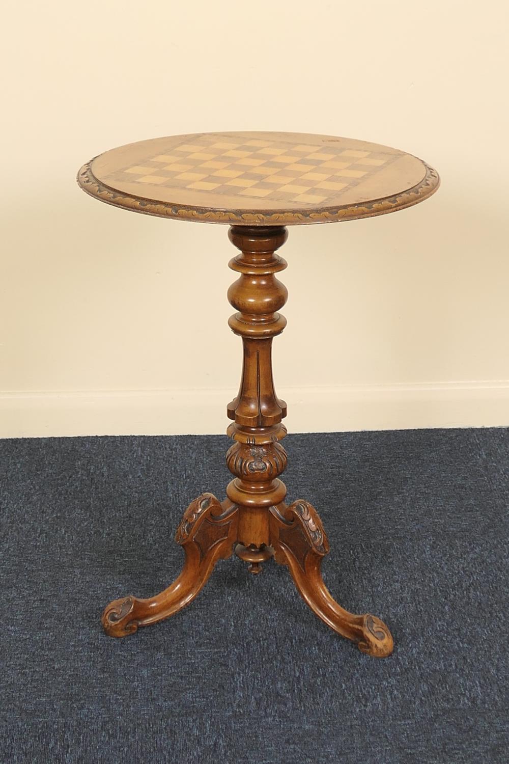 Victorian carved walnut and inlaid pedestal games table, circa 1875, the circular top with