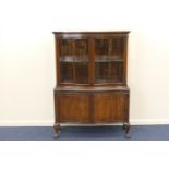 George V mahogany serpentine front display cabinet, circa 1910-20, having two glazed doors opening