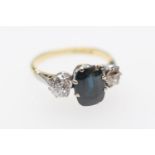 Sapphire and diamond three stone ring, the oval cut sapphire 8mm x 6mm, flanked by two old round cut