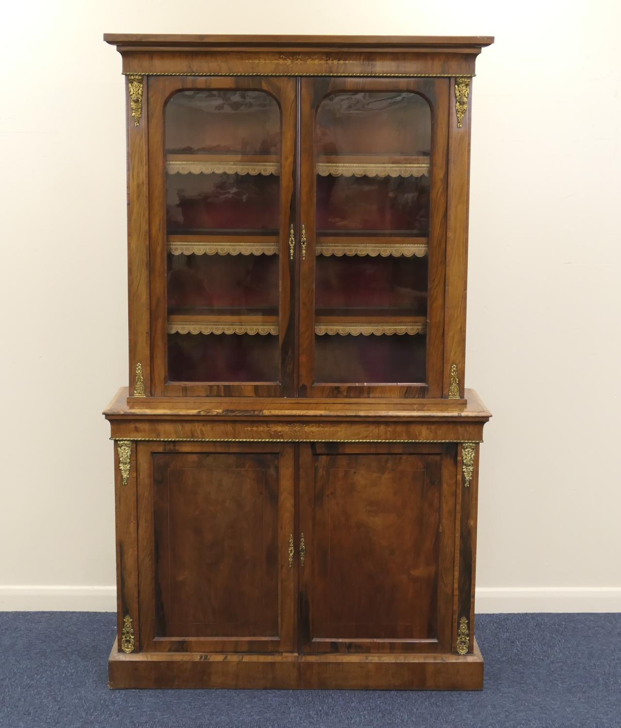 Victorian walnut and inlaid bookcase cabinet, circa 1870, having two glazed upper doors opening to