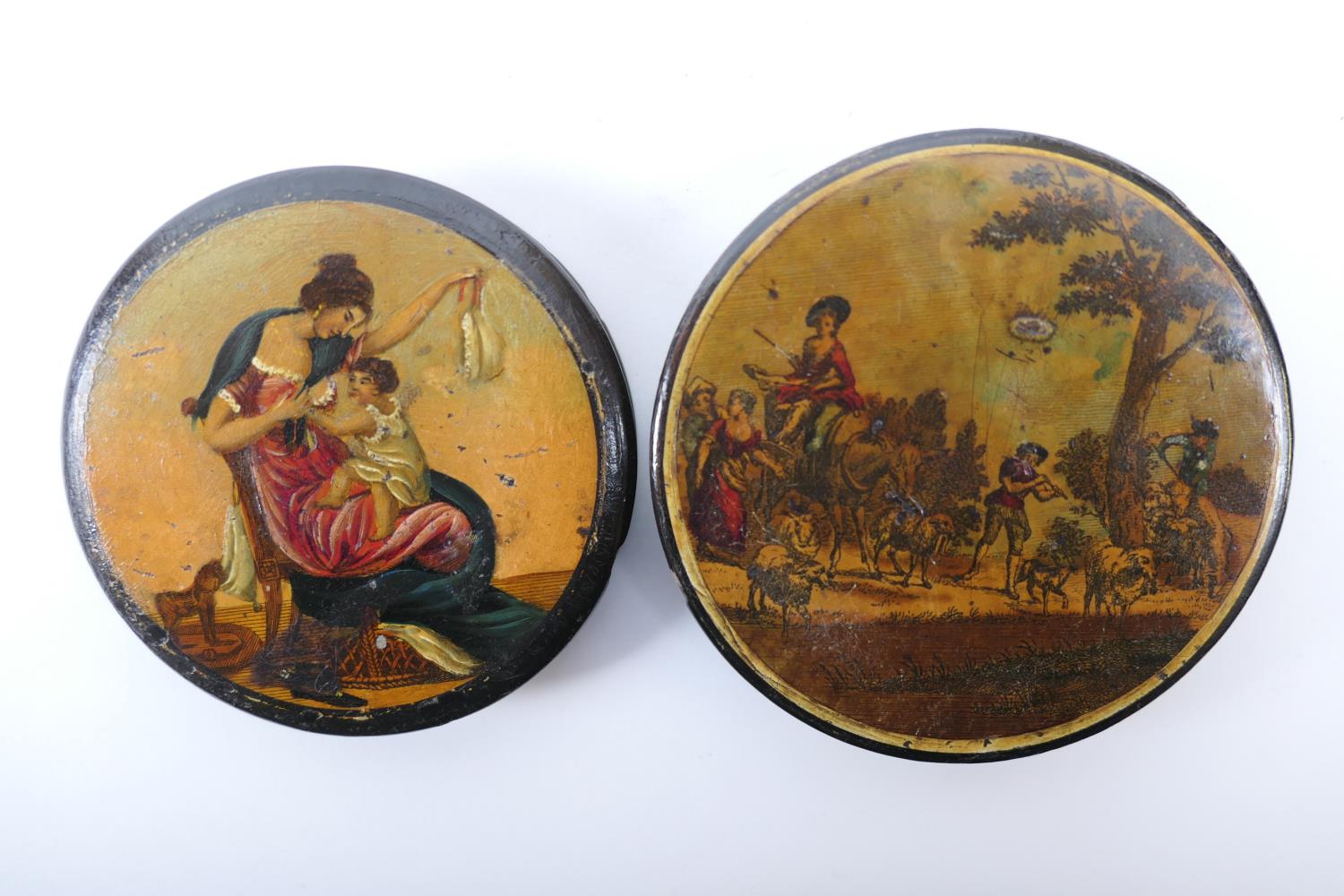 Two papier mache circular snuff boxes, each with printed cover decoration, 9cm and 8.5cm diameter