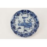 Delft blue and white dish, circa 1740-60, centred with a bird standing atop a vase in chinoiserie