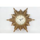 Sunburst wall clock, retailed by Phillips, Lime Street, Liverpool, the silvered dial with Arabic