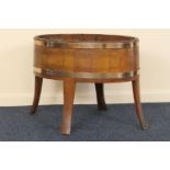 Late George III coopered mahogany cellarette, oval form with brass banding, metal liner, raised on