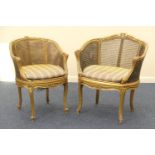 Two French gilt bergere tub chairs, early 20th Century, the larger with a single caned back,