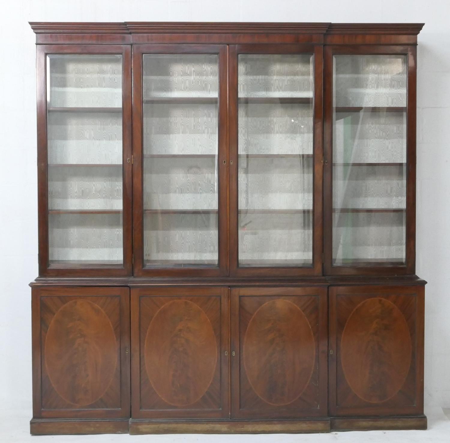 Late 19th Century mahogany and inlaid breakfront library bookcase, in Georgian style, having a