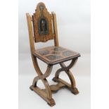 Italian walnut, ebony and ivory chip inlaid hall chair, circa 1900-20, the back worked with a knight