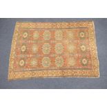 Hamadan woollen rug, red ground with three rows of blue and fawn reserves, within a fawn border (