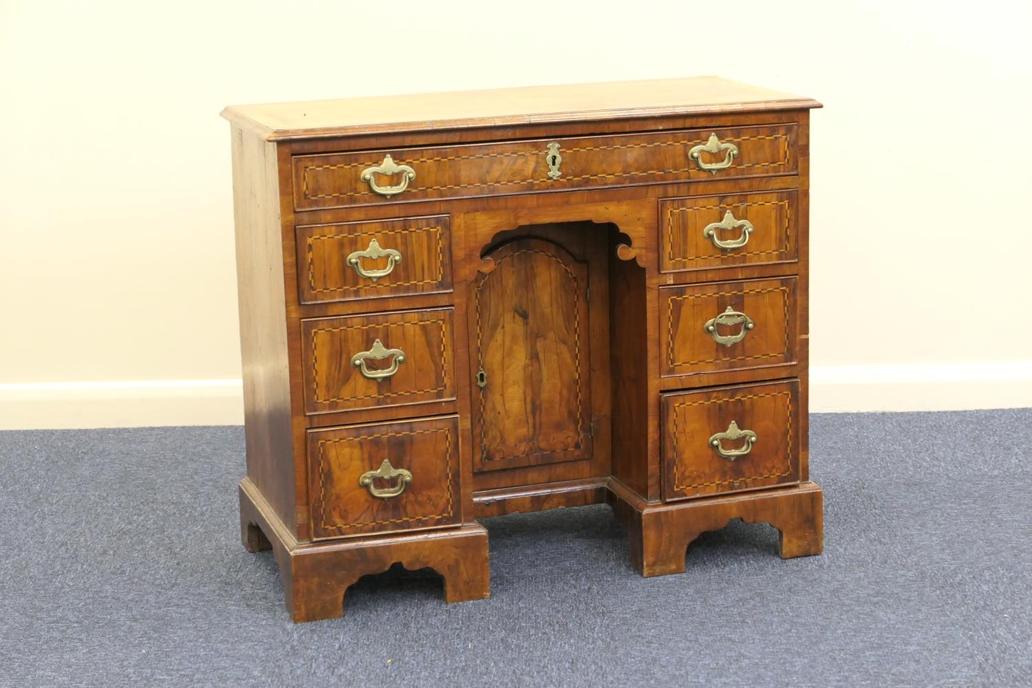 Walnut inlaid kneehole desk, 18th Century, quarter veneered top crossbanded and with ebony and