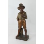 Large Goldscheider (Wien) figure, 'A pause for a smoke', a young itinerant traveller, painted and