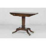 Regency rosewood and brass inlaid folding pedestal card table, circa 1810-20, the swivelling folding