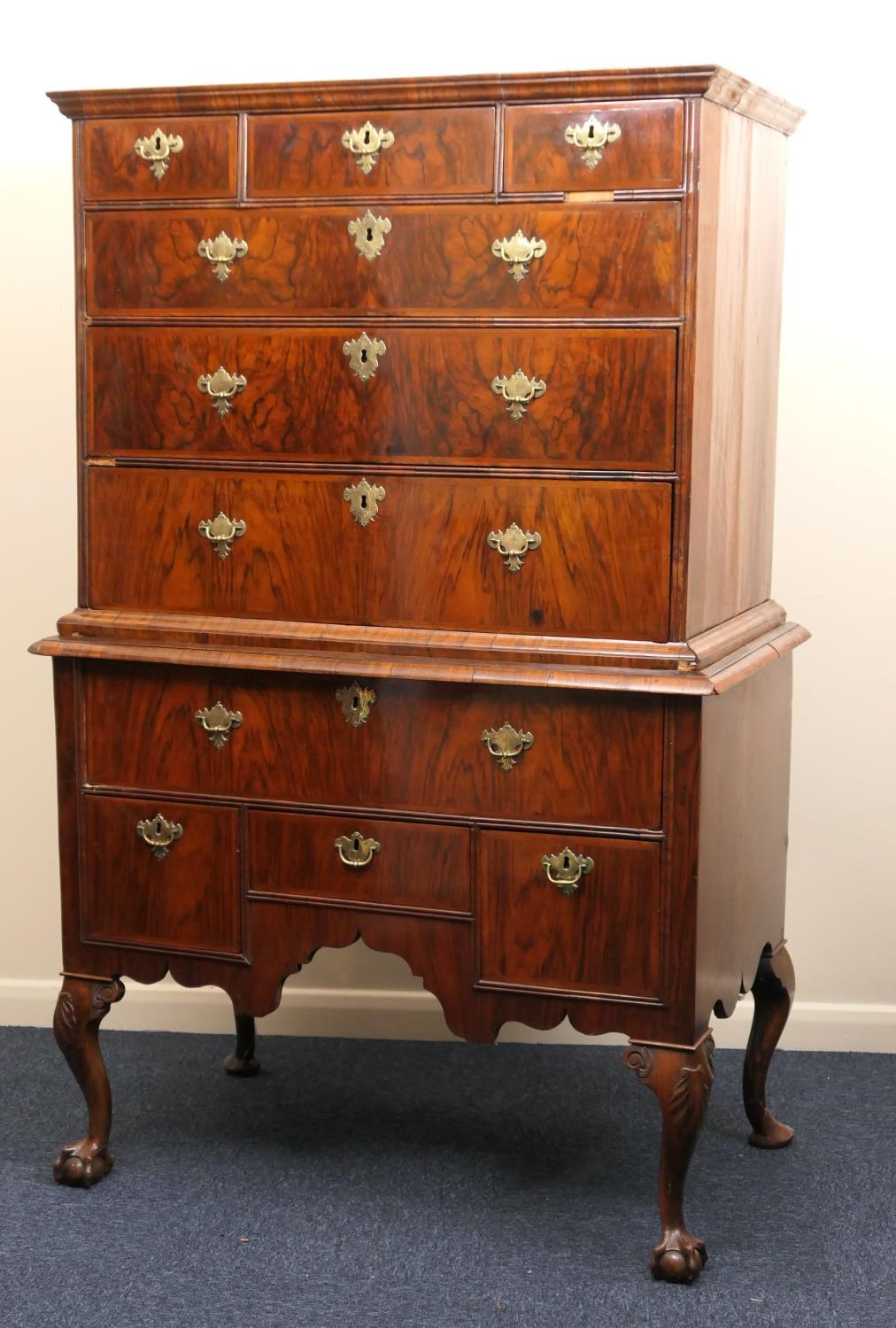 Walnut chest on stand, early 18th Century and later, the top with moulded cornice over three short