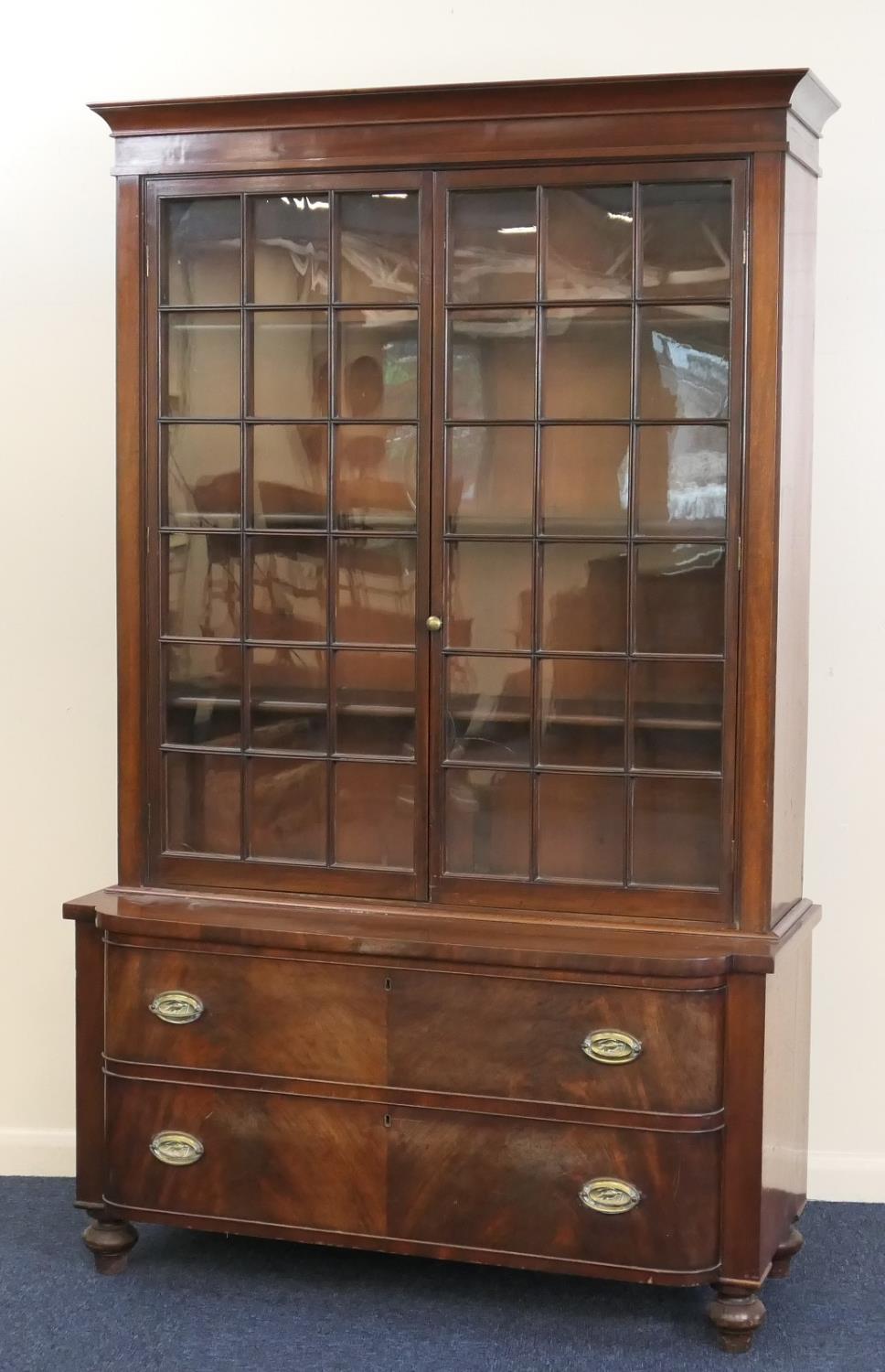 William IV mahogany bookcase chest, the top with glazed doors opening to three shelves, over a bow