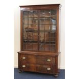 William IV mahogany bookcase chest, the top with glazed doors opening to three shelves, over a bow