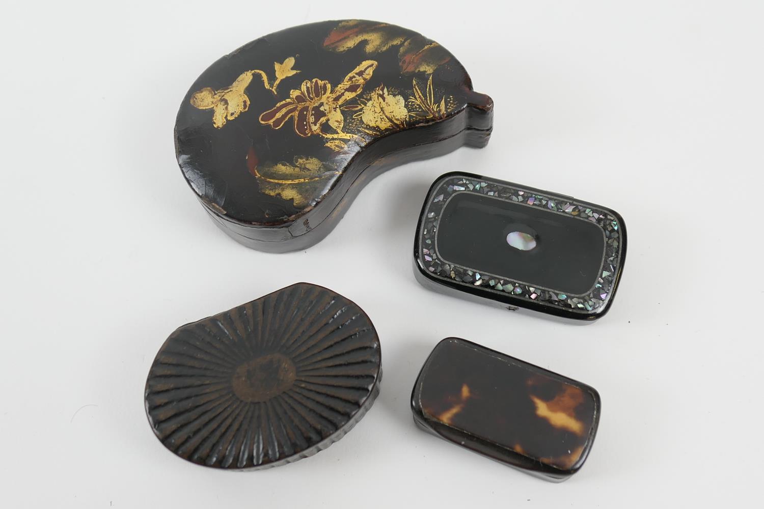 Three Victorian black lacquered papier mache snuff boxes, one of gourd shape with gilt floral