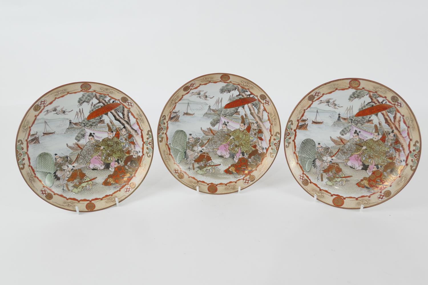 Three Japanese kutani saucer dishes, late Meiji (1868-1912), each decorated with figures at a