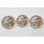 Three Japanese kutani saucer dishes, late Meiji (1868-1912), each decorated with figures at a