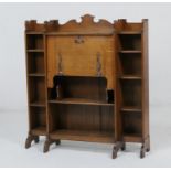 Arts and Crafts period oak open bureau, circa 1900-10, centred with a slope front with copper