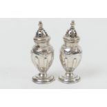 Pair of Edwardian silver pepperettes, by Henry Matthews, Birmingham 1905, each of ovoid form