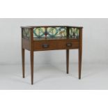 Arts and Crafts period oak writing table, circa 1900, having a three-quarter stained glass panel