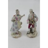 Pair of Sitzendorf porcelain figures of aristocratic courtiers, decorated in colours heightened with