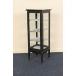 Late Victorian ebonised mahogany pillar display cabinet, circa 1890, with bevelled glazing on all