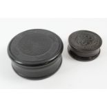 Two turned ebony circular snuff boxes, 8cm and 5cm diameter