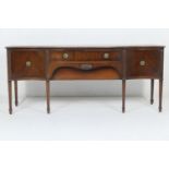 Waring & Gillow mahogany serpentine front sideboard, circa 1910, fitted with two central drawers