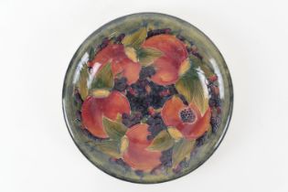 William Moorcroft Pomegranate plate, with everted rim, painted signature and impressed marks, 23cm