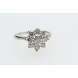 Diamond cluster ring, the central round brilliant diamond of approx. 0.35ct bordered with eight