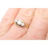 Diamond three stone ring, round brilliant cut diamonds illusion set in platinum in a crossover mount