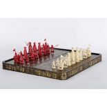 Chess pieces and a chess and backgammon board closing in a box shape