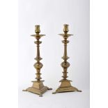 A pair of candlesticks with a triangle base