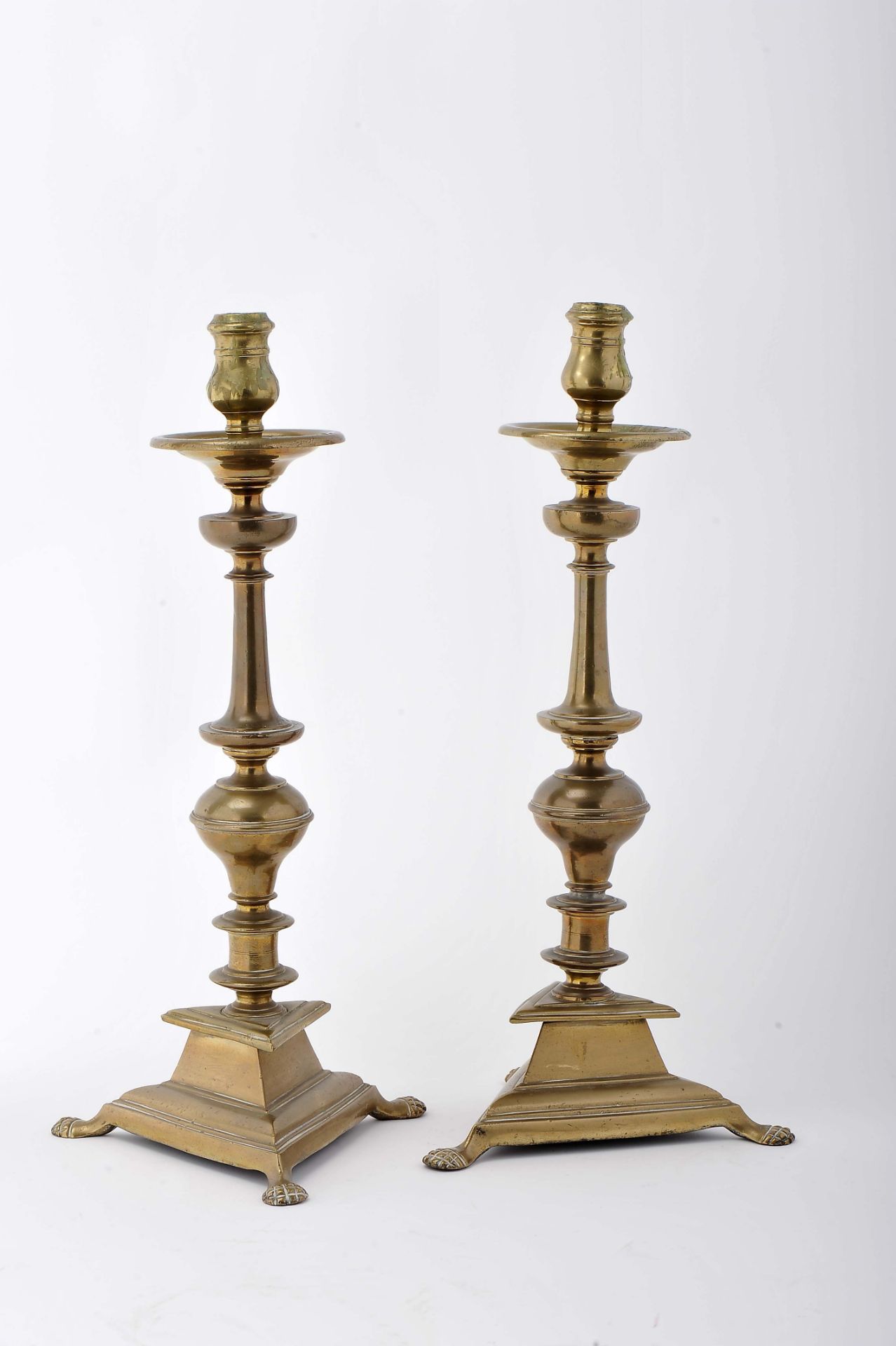 A pair of candlesticks with a triangle base