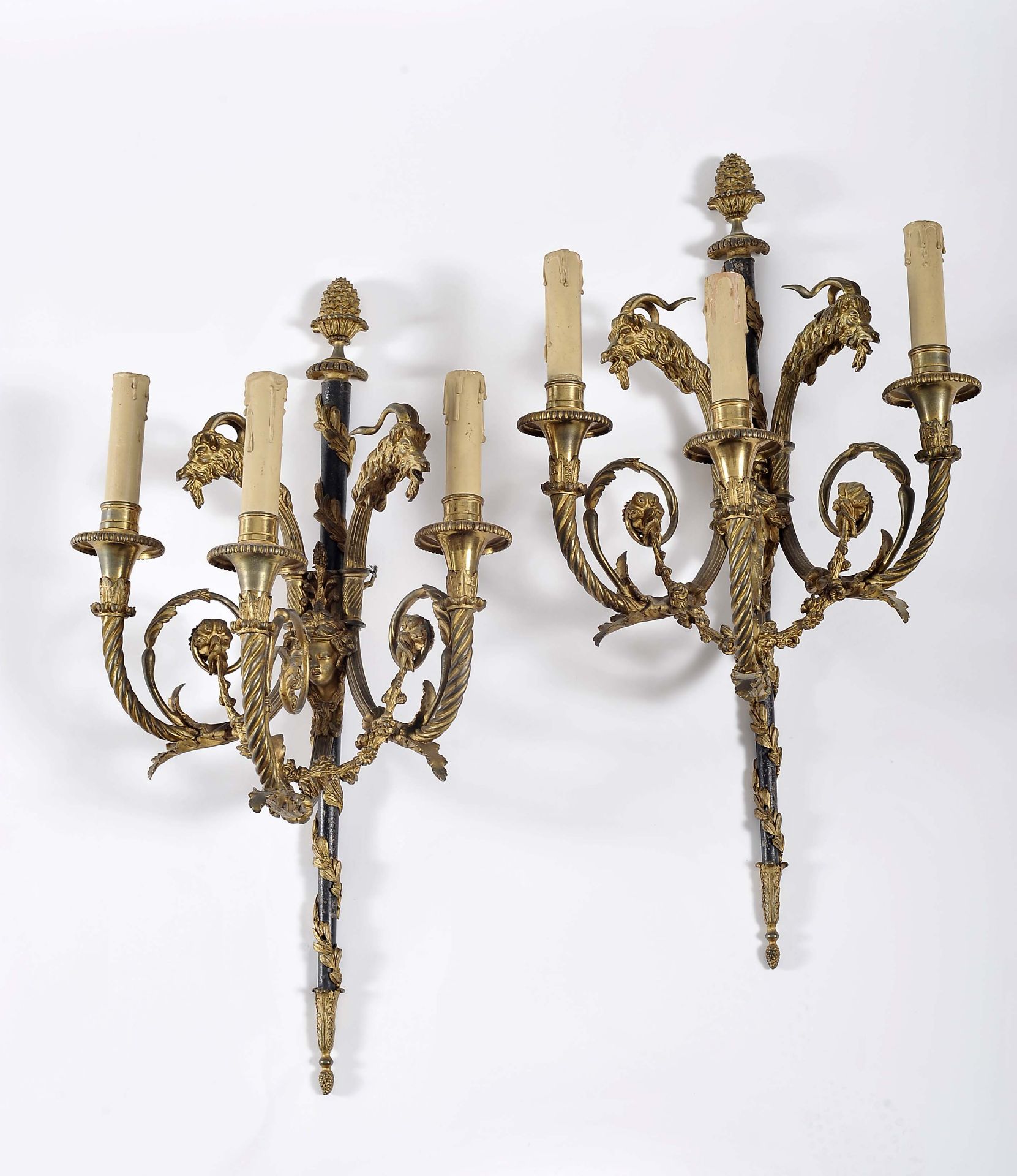A pair of three-light wall sconces