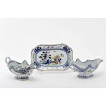 A pair of scalloped sauce boats and stand